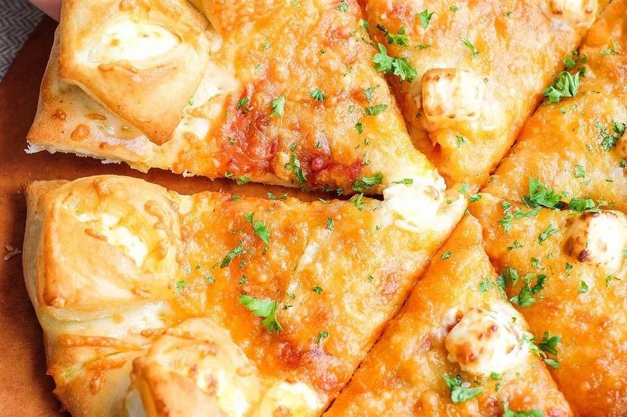 Stuffed Crazy Crust pepperoni pizza, cheese pulling from the stuffed crust