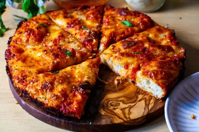 Thin crust pepperoni pizza, whole with a cracker-crisp base